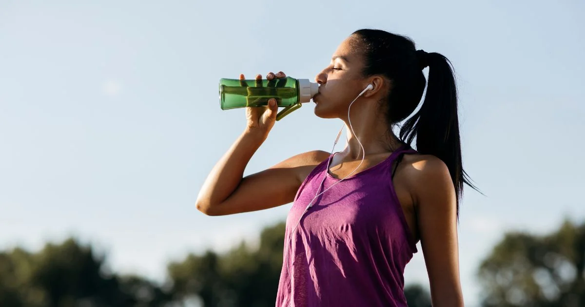 Woman drinking water after a workout
